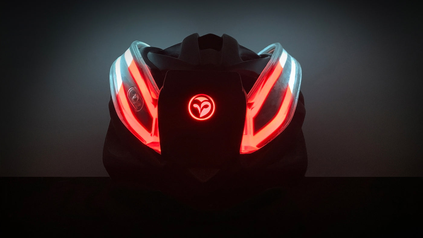 Back view of NightBlazr attached to cycle helmet turned on, showing red and white electroluminescent light blades