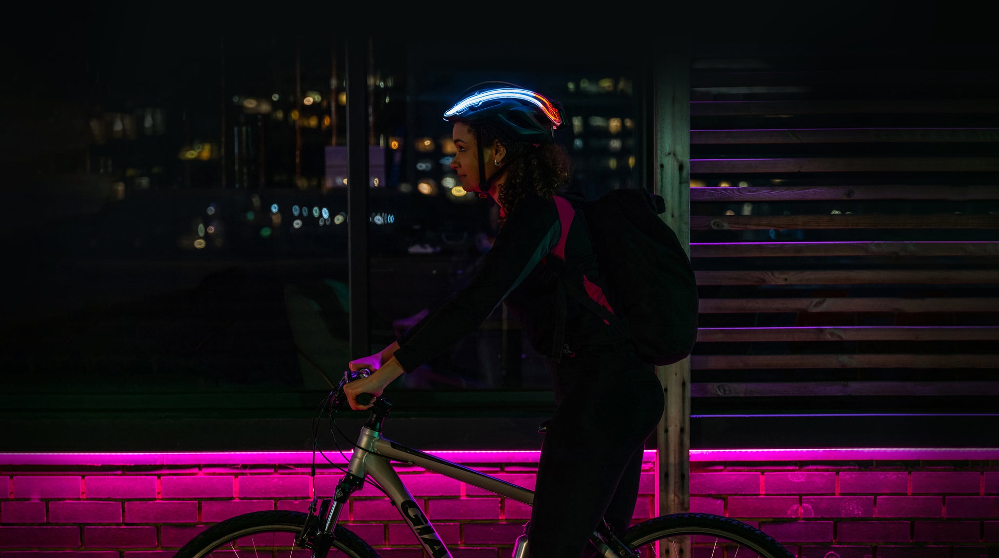 Female on bike with NightBlaz attached to her cycle helmet