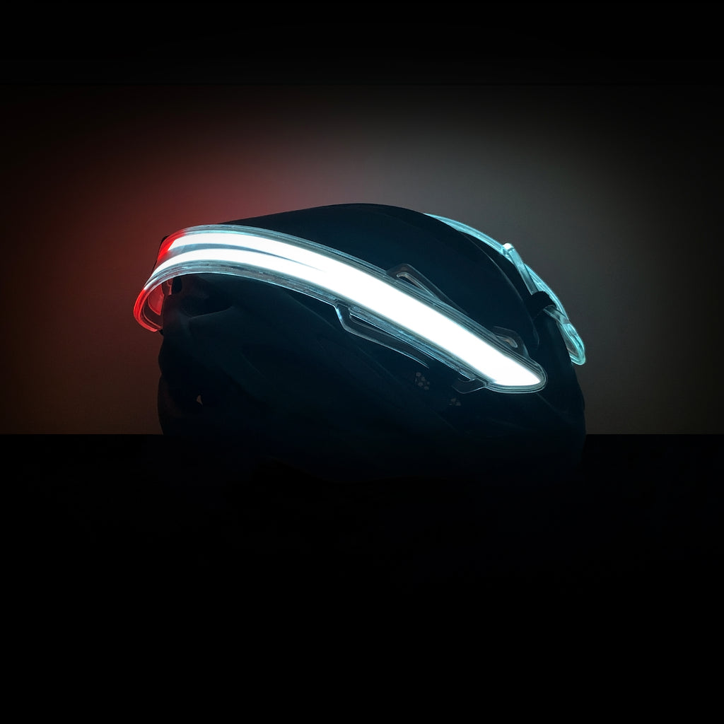 3/4 front view of NightBlazr attached to cycle helmet turned on, showing electroluminescent light blades